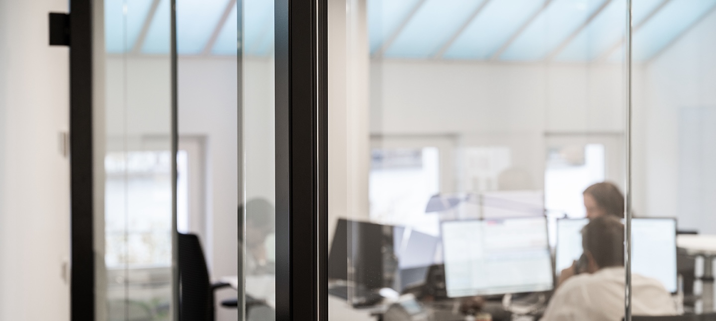 Office with people working in front of computer screens