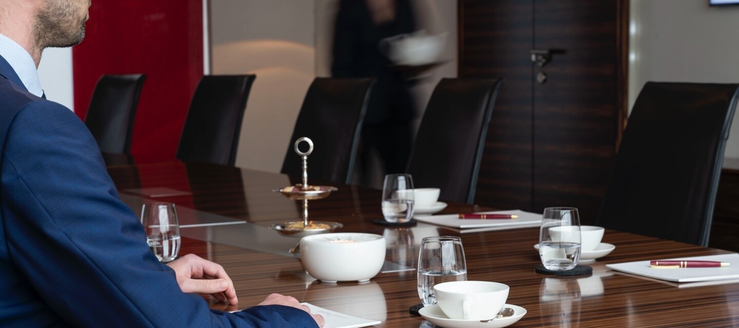 man sitting at a conference table man sitting at a conference table