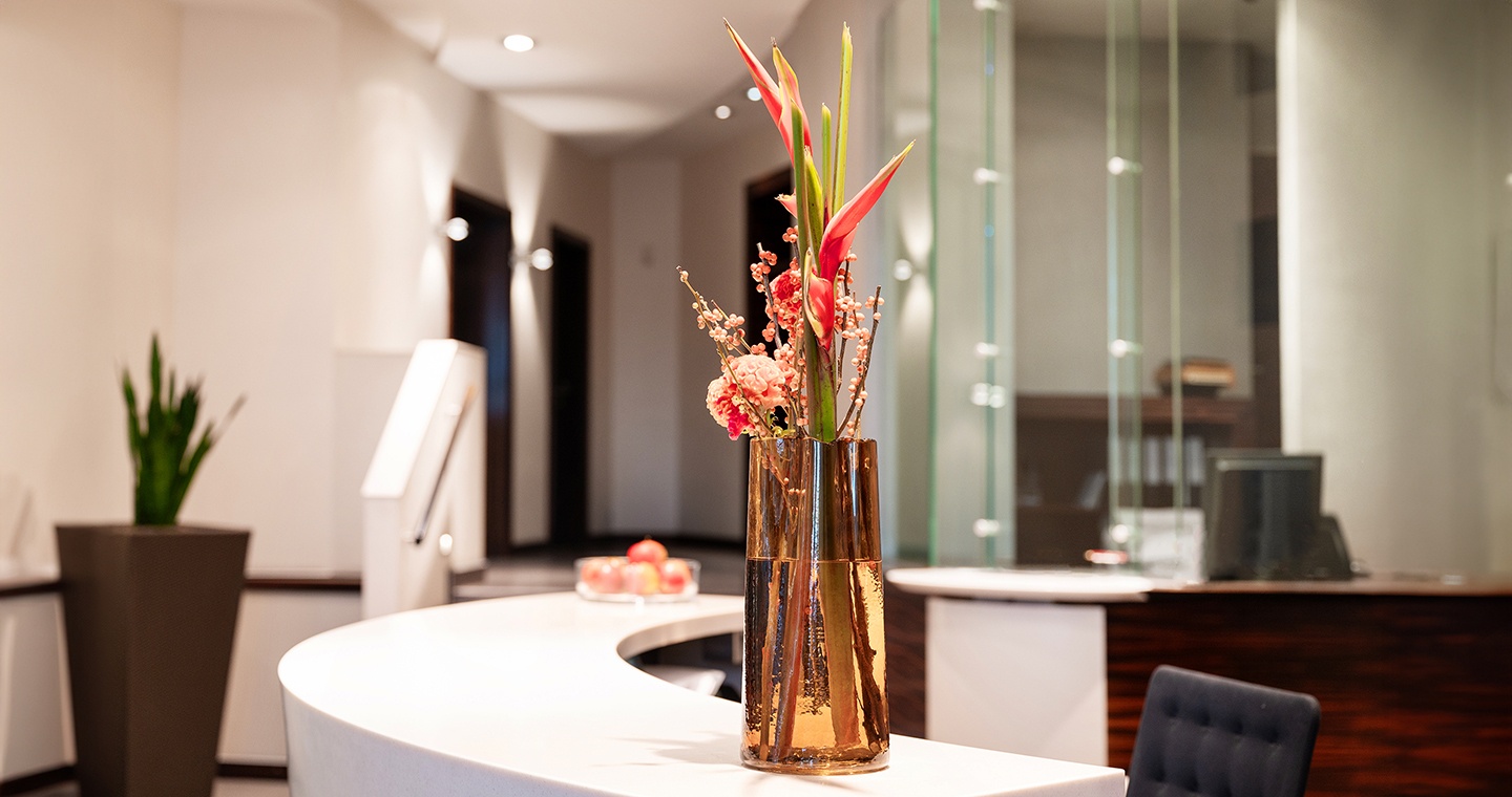 Flower stands on reception desk Flower stands on reception desk